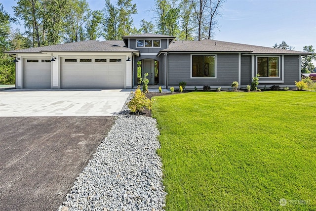 view of front of property with a garage, driveway, and a front lawn