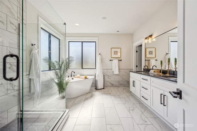 bathroom with tile walls, shower with separate bathtub, and vanity