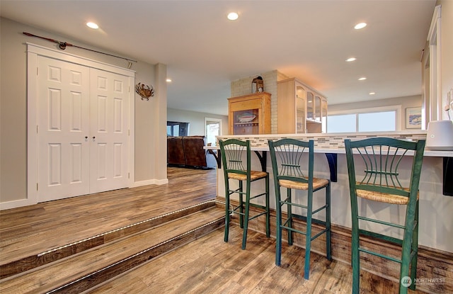 24424 Sandridge Rd, Ocean Park, WA 98640 - kitchen with wood finished floors, recessed lighting, a breakfast bar, and baseboards