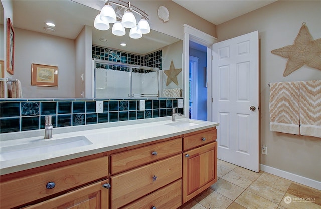24424 Sandridge Rd, Ocean Park, WA 98640 - full bathroom featuring double vanity, a chandelier, a stall shower, tile patterned floors, and baseboards