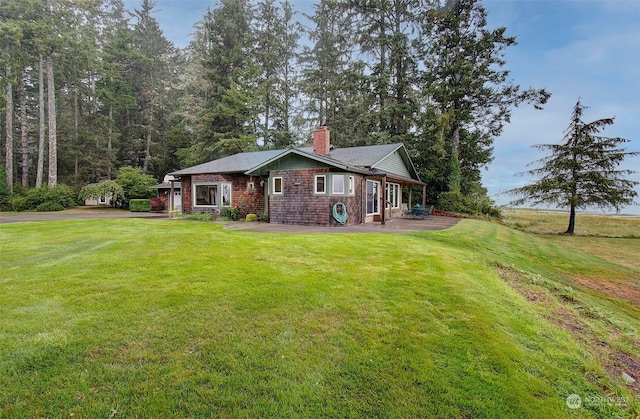 24424 Sandridge Rd, Ocean Park, WA 98640 - view of front of home with a chimney, a front yard, and a patio