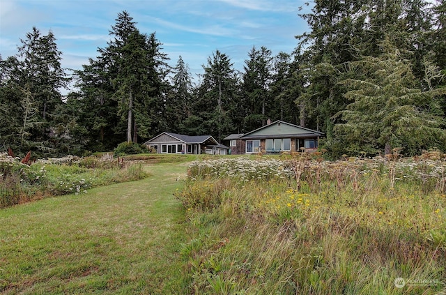 24424 Sandridge Rd, Ocean Park, WA 98640 - view of front of home with a front yard and a wooded view