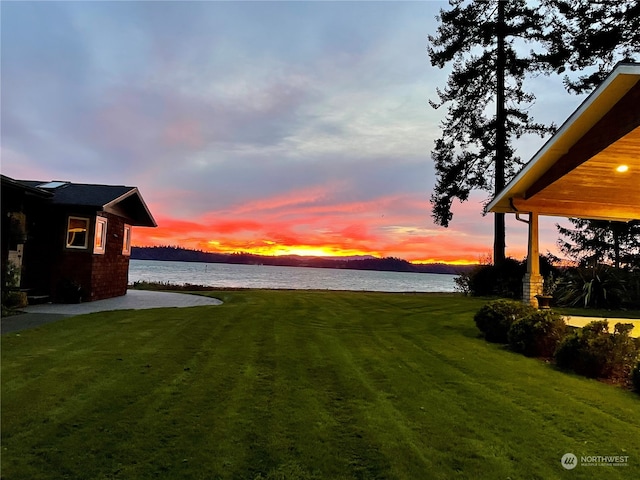 yard at dusk with a water view