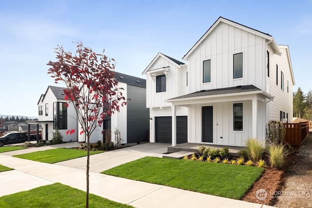 modern inspired farmhouse featuring a porch, a garage, and a front lawn