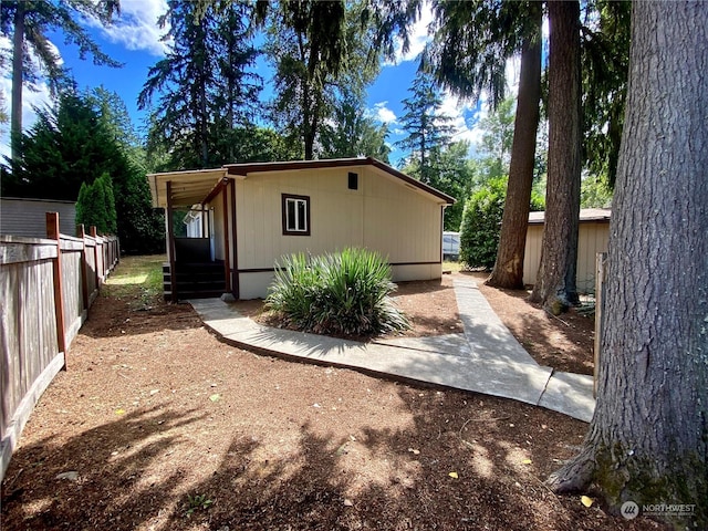 view of property exterior featuring fence