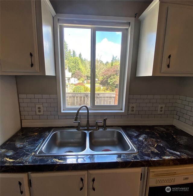 kitchen featuring a sink, white cabinets, decorative backsplash, dishwasher, and dark countertops