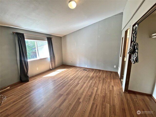 empty room with visible vents and wood finished floors