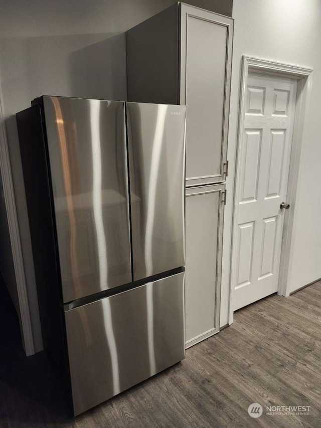 kitchen featuring wood-type flooring and stainless steel fridge