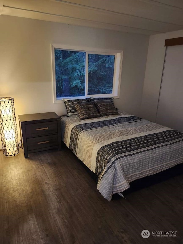 bedroom with dark hardwood / wood-style flooring