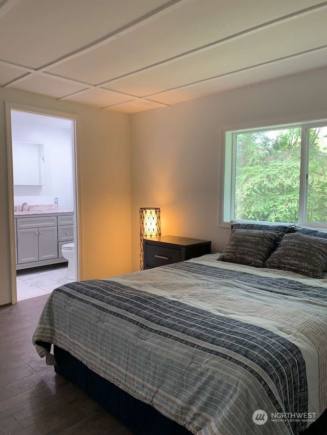 bedroom featuring sink and hardwood / wood-style flooring