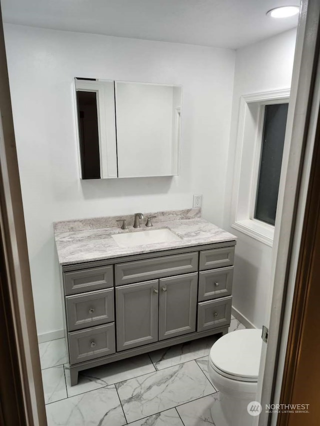 bathroom featuring vanity and toilet