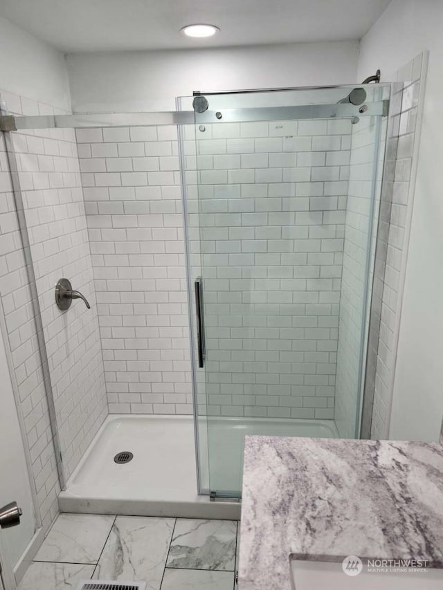 bathroom with a shower with door