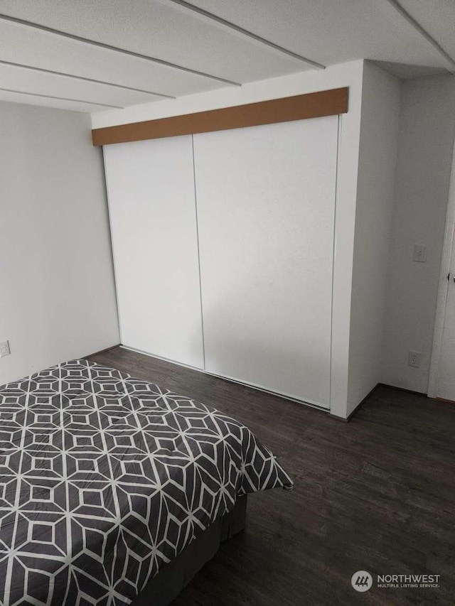 unfurnished bedroom with dark hardwood / wood-style floors