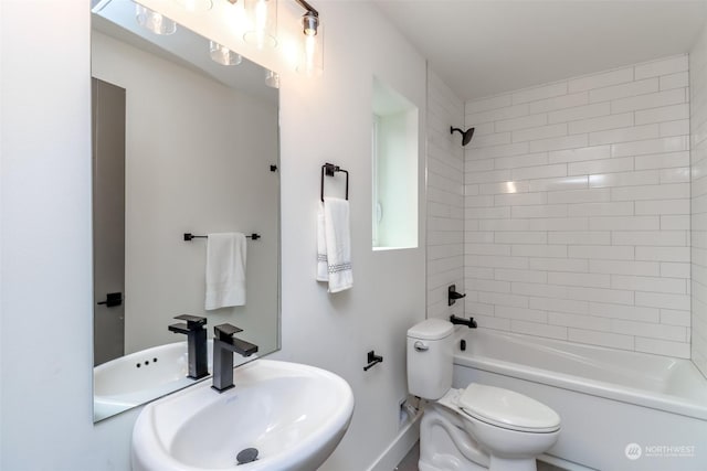 bathroom with toilet, a sink, and shower / bathtub combination