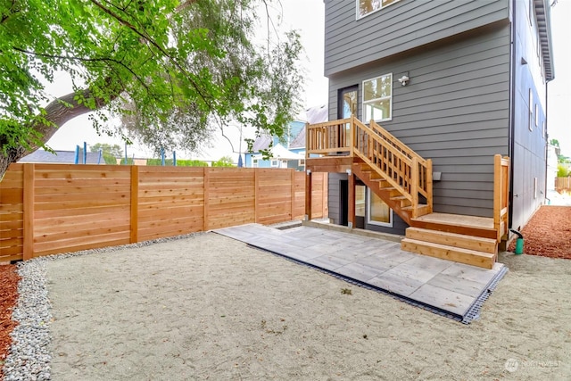 view of yard with fence private yard, a patio area, and stairway