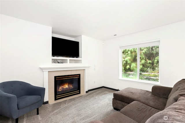 carpeted living room featuring a fireplace