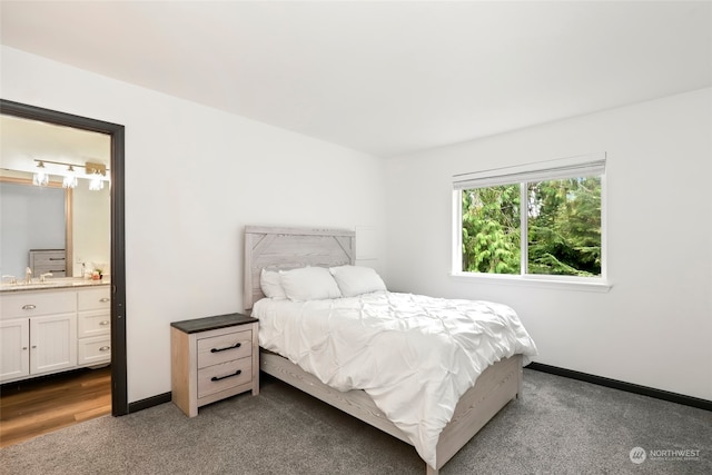 bedroom featuring light hardwood / wood-style flooring and connected bathroom