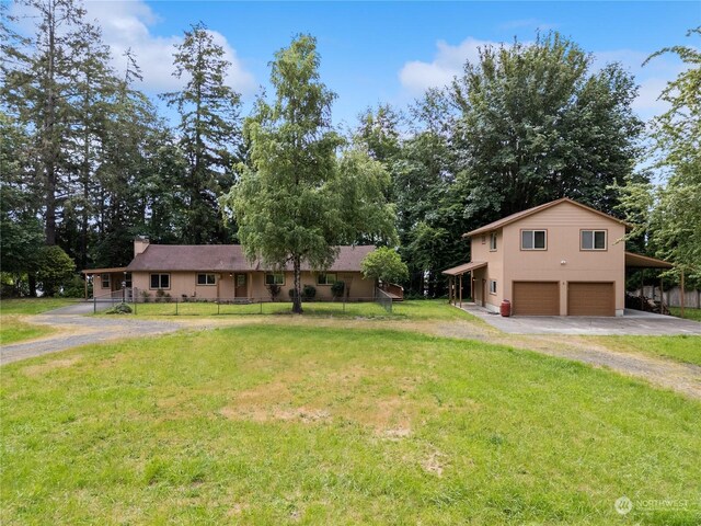 view of front of property featuring a garage and a front lawn