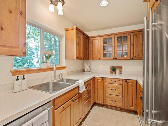 kitchen featuring appliances with stainless steel finishes, light tile patterned floors, and sink