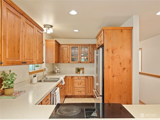 kitchen featuring light tile patterned flooring, appliances with stainless steel finishes, and sink