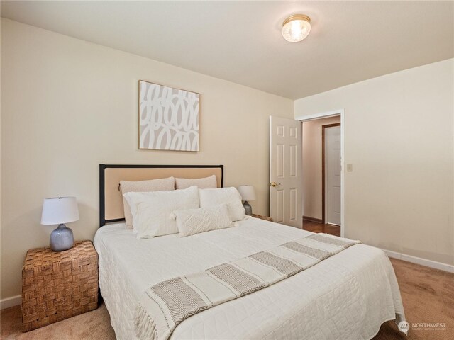 bedroom featuring light colored carpet