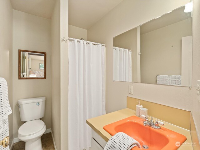 bathroom featuring vanity and toilet