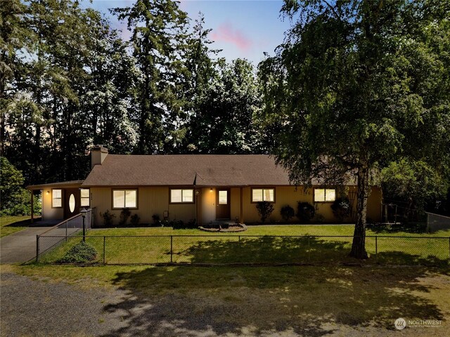 ranch-style house featuring a lawn