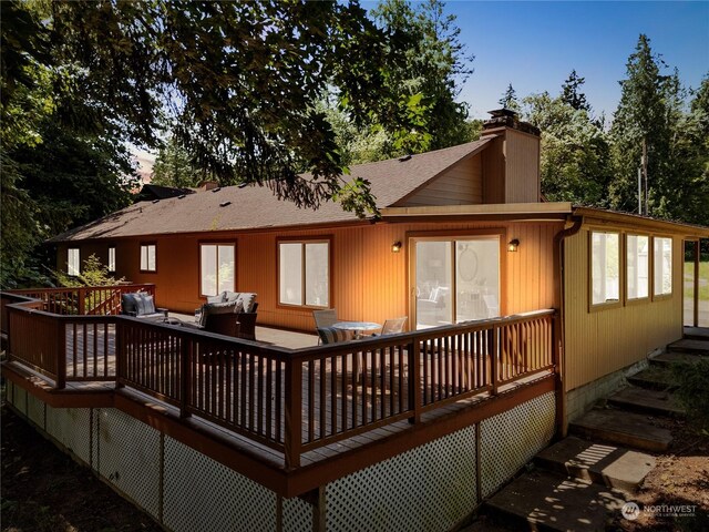 rear view of house with a wooden deck