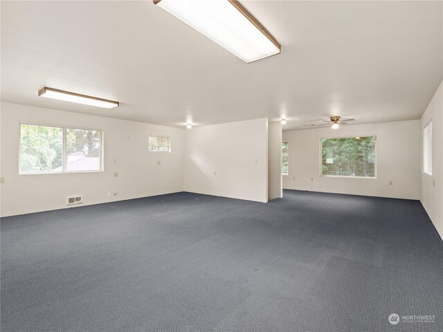 spare room featuring ceiling fan and carpet floors