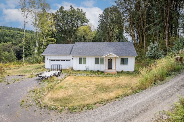 view of front of house with a garage and a front lawn