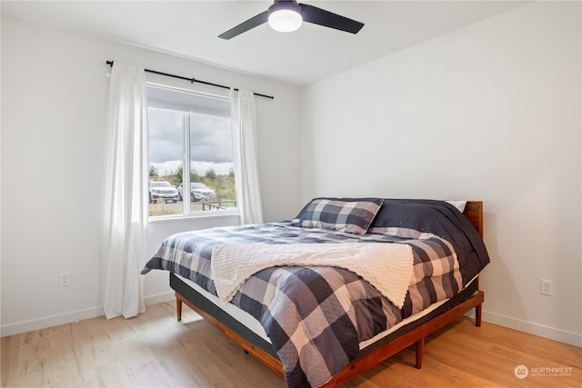 bedroom with ceiling fan and light hardwood / wood-style flooring