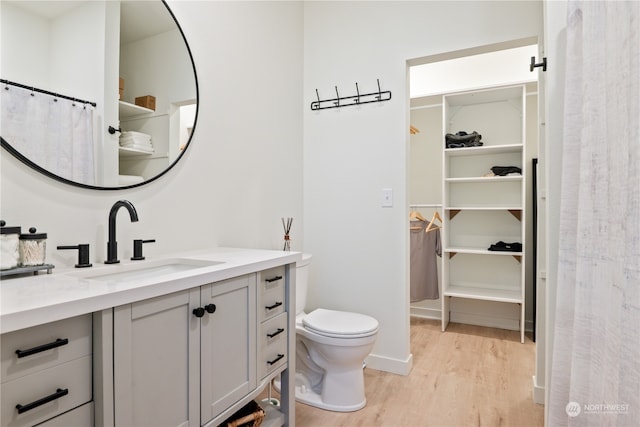 bathroom featuring hardwood / wood-style floors, toilet, and vanity