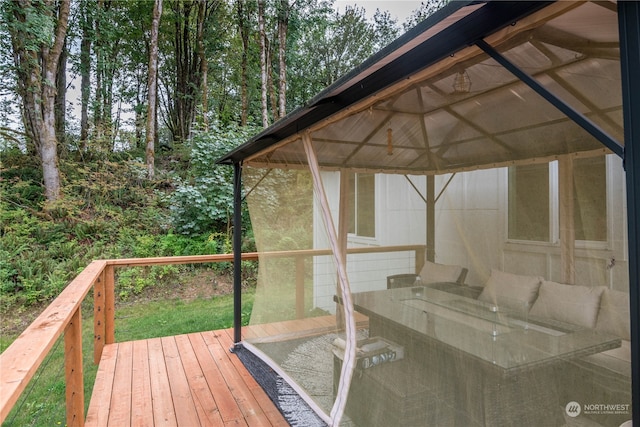 wooden terrace featuring a gazebo