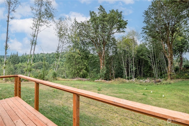 wooden terrace with a lawn