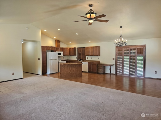 interior space with ceiling fan with notable chandelier, high vaulted ceiling, and dark carpet