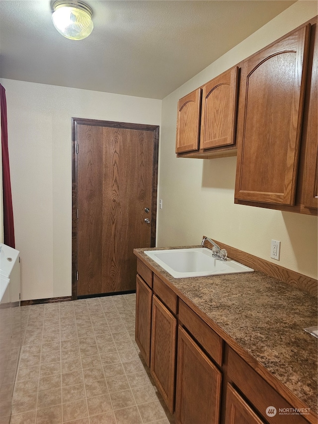 kitchen with sink and light tile patterned floors