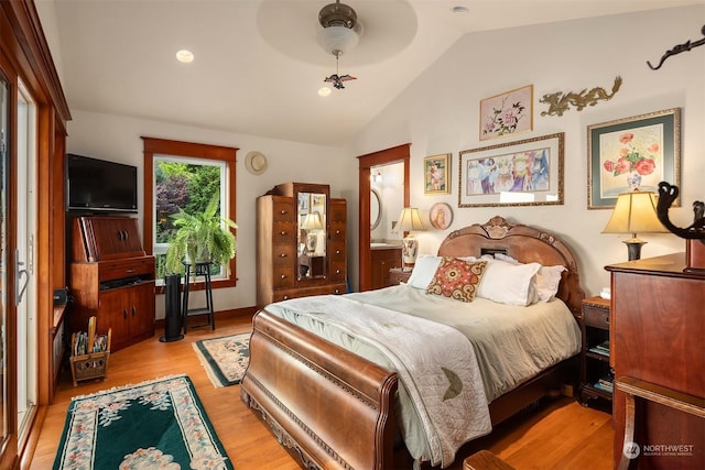 bedroom with ceiling fan, light wood-type flooring, and vaulted ceiling