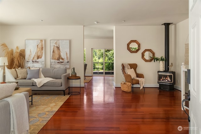 living room featuring a wood stove and dark hardwood / wood-style floors