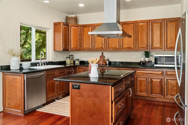 kitchen featuring island range hood, a kitchen island, sink, dark wood-type flooring, and appliances with stainless steel finishes