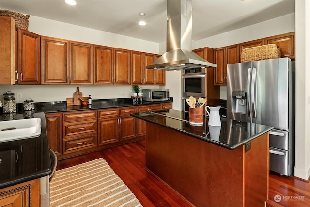 kitchen with appliances with stainless steel finishes, dark hardwood / wood-style floors, a center island, and island range hood