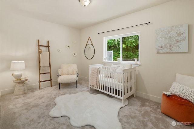 bedroom with carpet and a crib