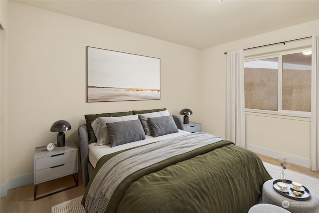 bedroom with hardwood / wood-style flooring