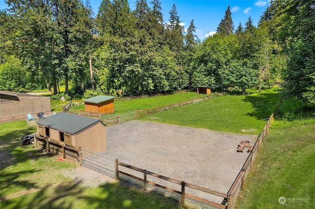 view of property's community with an outdoor structure and a lawn