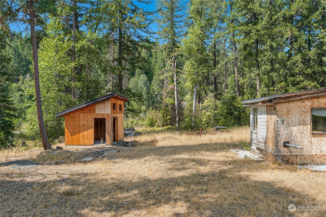 view of shed featuring a forest view