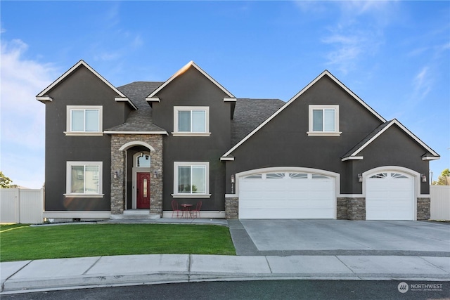 traditional-style home with stone siding, driveway, and stucco siding