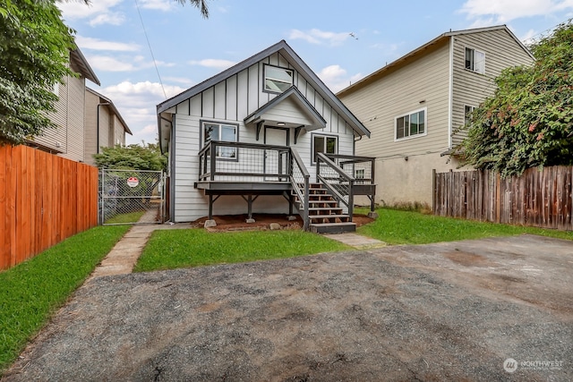 rear view of house featuring a wooden deck