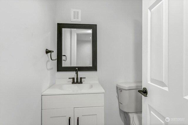 bathroom featuring toilet and vanity