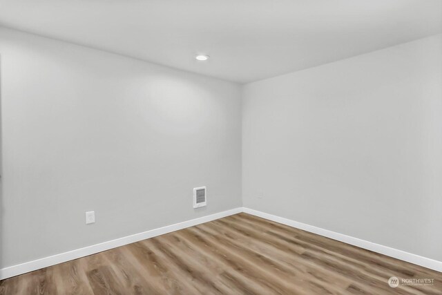 spare room with wood-type flooring