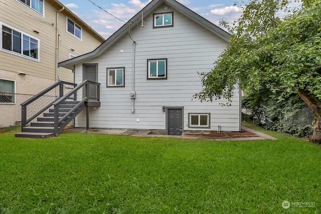 back of house with a lawn