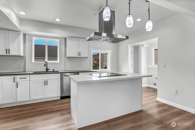 kitchen with pendant lighting, wood-type flooring, island range hood, black electric cooktop, and sink